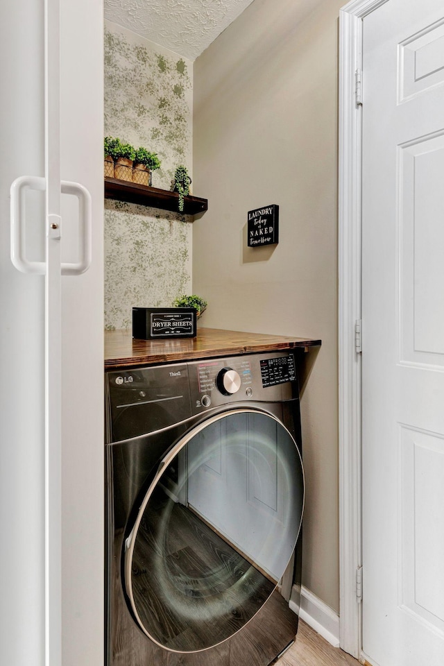 7646 S Swift Rd, Goodlettsville, TN 37072 - washroom with washer / dryer, light wood-type flooring, and a textured ceiling