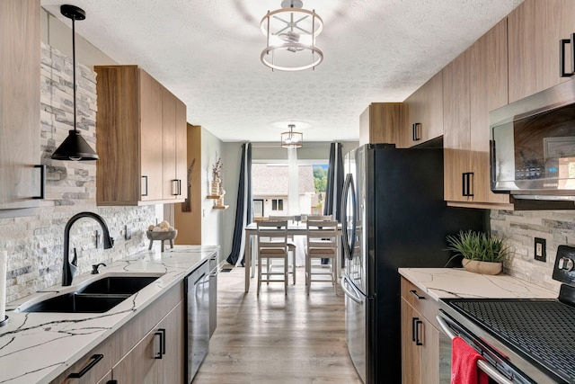 7646 S Swift Rd, Goodlettsville, TN 37072 - kitchen with stainless steel appliances, a textured ceiling, backsplash, light stone counters, and light wood-style floors