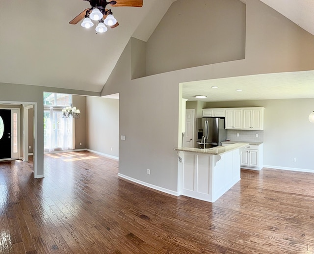 740 N Palmers Chapel Rd, White House, TN 37188 - unfurnished living room featuring high vaulted ceiling, a ceiling fan, wood finished floors, and a chandelier