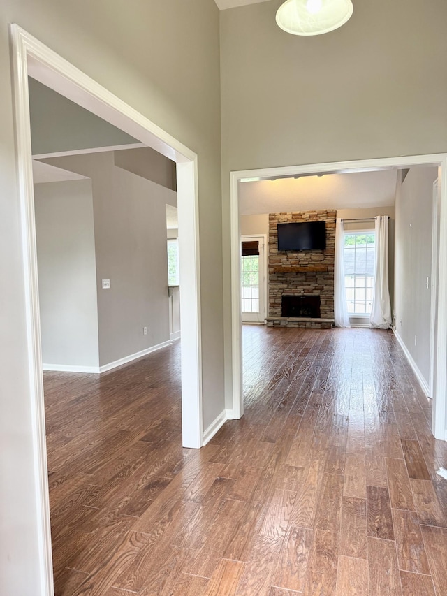 740 N Palmers Chapel Rd, White House, TN 37188 - unfurnished living room featuring hardwood / wood-style floors, plenty of natural light, a high ceiling, and a fireplace