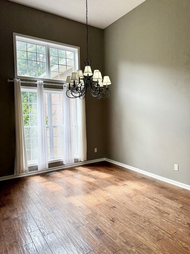 740 N Palmers Chapel Rd, White House, TN 37188 - unfurnished room featuring a chandelier and wood finished floors