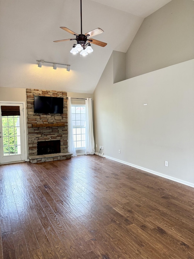 740 N Palmers Chapel Rd, White House, TN 37188 - unfurnished living room featuring track lighting, a ceiling fan, hardwood / wood-style floors, a stone fireplace, and high vaulted ceiling