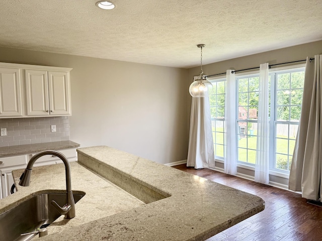740 N Palmers Chapel Rd, White House, TN 37188 - kitchen with light stone counters, white cabinets, dark wood-type flooring, decorative backsplash, and a textured ceiling