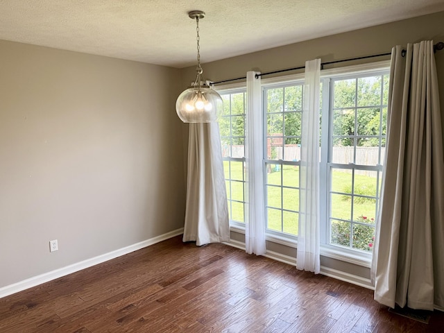 740 N Palmers Chapel Rd, White House, TN 37188 - unfurnished dining area featuring dark wood-style floors, a textured ceiling, and healthy amount of natural light