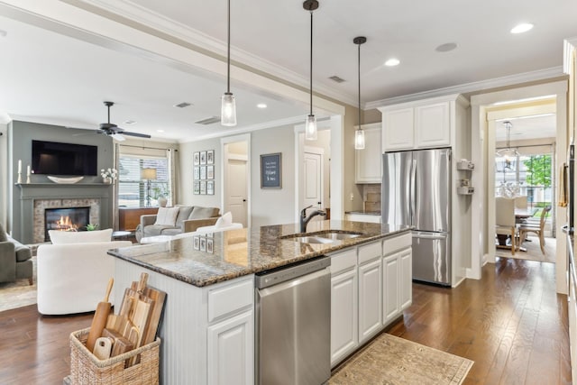 600 Tywater Crossing Blvd, Franklin, TN 37064 - kitchen featuring stainless steel appliances, dark wood-style floors, a center island with sink, a glass covered fireplace, and ceiling fan