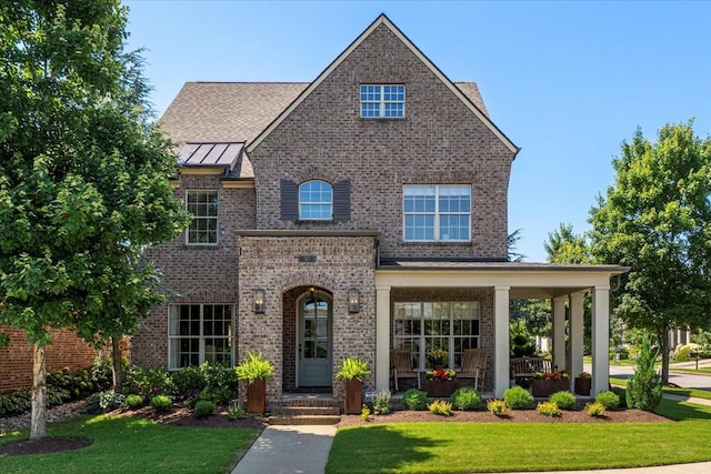 600 Tywater Crossing Blvd, Franklin, TN 37064 - view of front of property featuring a front lawn, brick siding, covered porch, and a standing seam roof