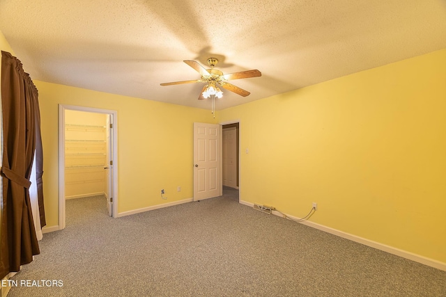 100 Cusick Cir, Lenoir City, TN 37772 - unfurnished bedroom with carpet floors, a walk in closet, ceiling fan, and a textured ceiling