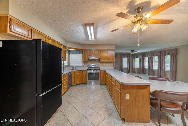 100 Cusick Cir, Lenoir City, TN 37772 - kitchen featuring black appliances, a peninsula, a textured ceiling, light countertops, and brown cabinets