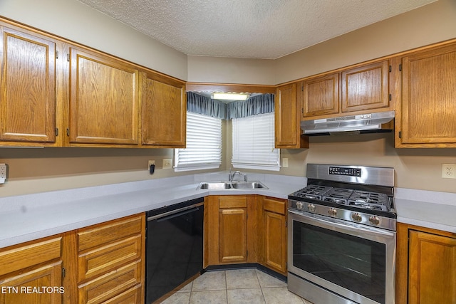 100 Cusick Cir, Lenoir City, TN 37772 - kitchen with stainless steel gas range, dishwasher, under cabinet range hood, light countertops, and a textured ceiling