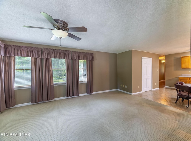 100 Cusick Cir, Lenoir City, TN 37772 - unfurnished living room with ceiling fan, light carpet, and a textured ceiling