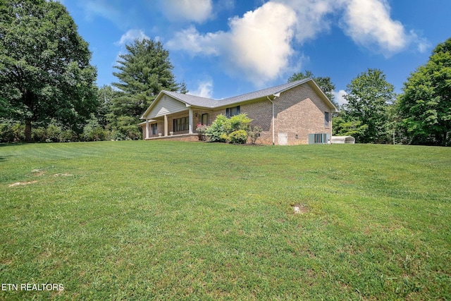 100 Cusick Cir, Lenoir City, TN 37772 - view of front of house featuring brick siding, a front yard, and covered porch