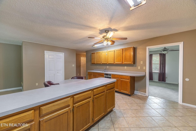 100 Cusick Cir, Lenoir City, TN 37772 - kitchen featuring ceiling fan, light countertops, a textured ceiling, brown cabinets, and light tile patterned flooring