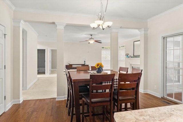 1164 Sydney Ter, Mount Juliet, TN 37122 - dining room featuring a ceiling fan, dark wood-style floors, ornate columns, ornamental molding, and a chandelier