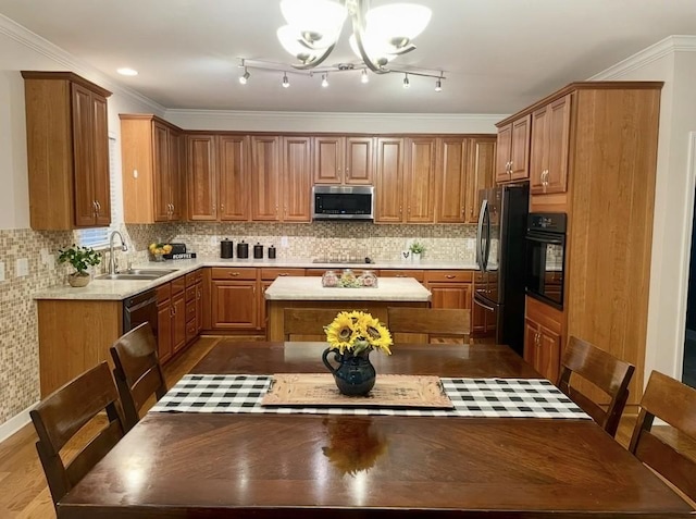 1164 Sydney Ter, Mount Juliet, TN 37122 - kitchen featuring black appliances, a kitchen island, light countertops, and a chandelier