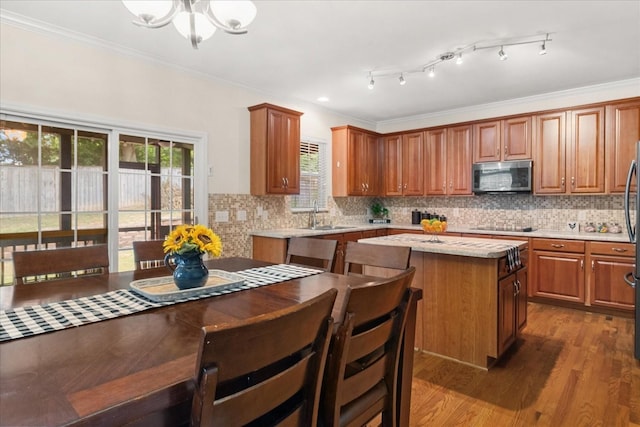 1164 Sydney Ter, Mount Juliet, TN 37122 - kitchen with stainless steel microwave, light countertops, a kitchen island, dark wood-style flooring, and brown cabinets