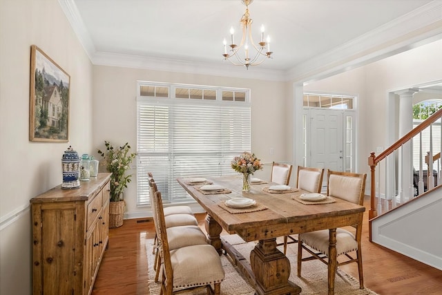 1164 Sydney Ter, Mount Juliet, TN 37122 - dining space with a chandelier, light wood-style flooring, ornamental molding, and stairs