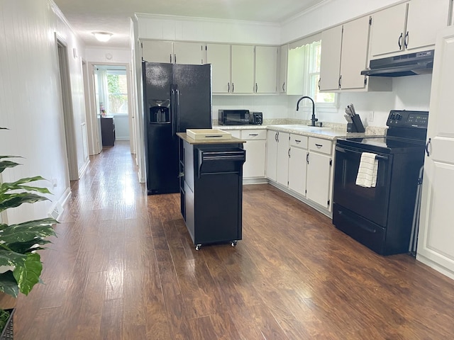 2801 Denham Ave, Columbia, TN 38401 - kitchen with black appliances, under cabinet range hood, crown molding, a kitchen island, and light countertops