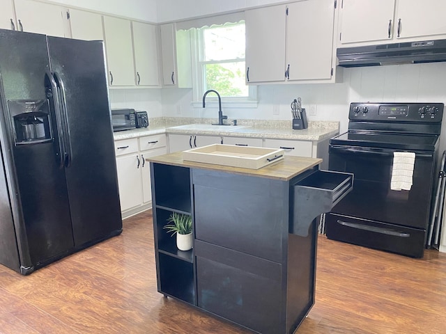 2801 Denham Ave, Columbia, TN 38401 - kitchen featuring black appliances, under cabinet range hood, dark wood-style floors, light countertops, and a kitchen island