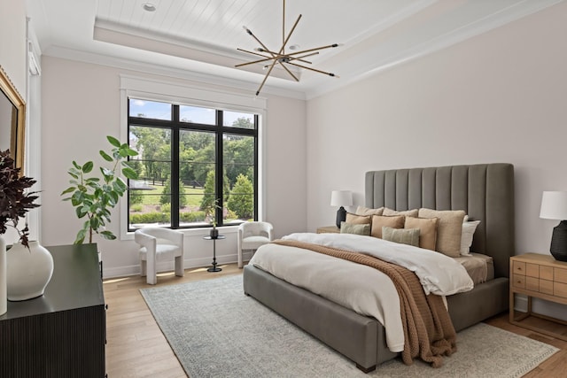 4896 Bethesda Rd, Thompsons Station, TN 37179 - bedroom with a tray ceiling, light wood-style flooring, ornamental molding, and a chandelier