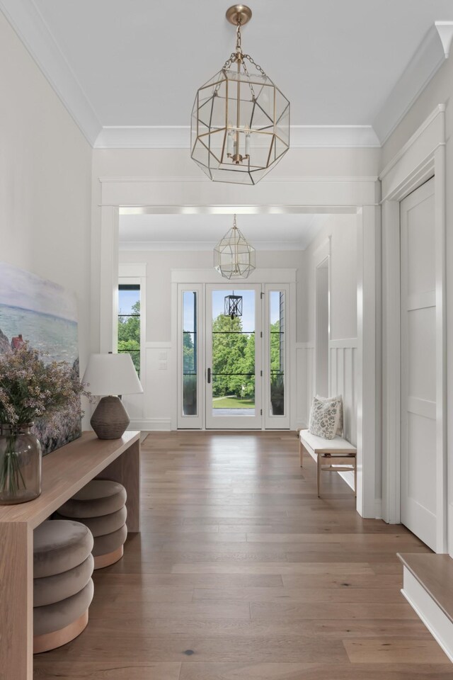 4896 Bethesda Rd, Thompsons Station, TN 37179 - entryway with a chandelier, healthy amount of natural light, ornamental molding, wood finished floors, and a decorative wall