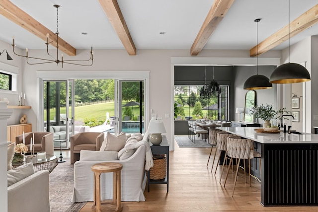 4896 Bethesda Rd, Thompsons Station, TN 37179 - living area featuring light wood-style floors, plenty of natural light, beam ceiling, and a chandelier