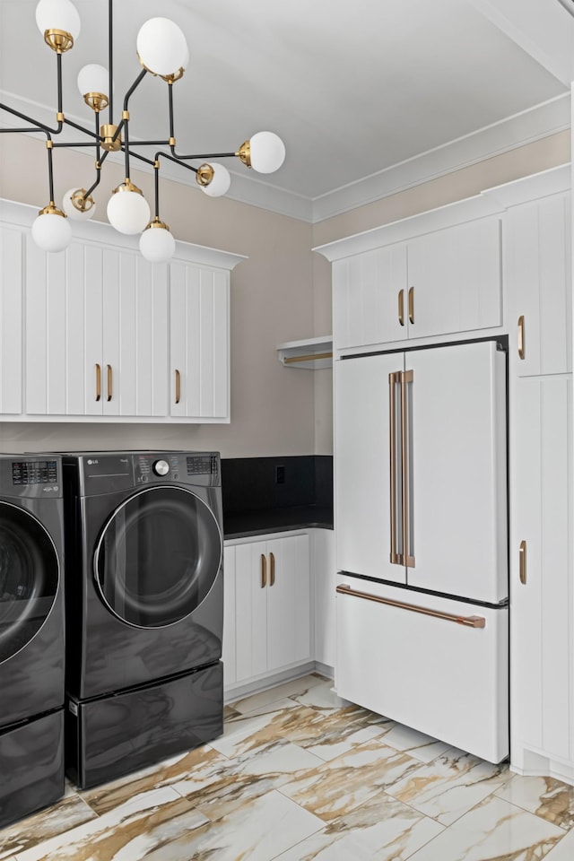 4896 Bethesda Rd, Thompsons Station, TN 37179 - laundry area featuring independent washer and dryer, light marble finish floors, cabinet space, and crown molding