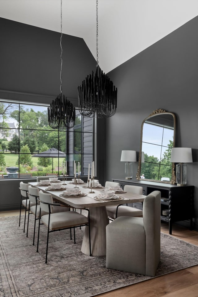 4896 Bethesda Rd, Thompsons Station, TN 37179 - dining space with a chandelier, high vaulted ceiling, and wood finished floors