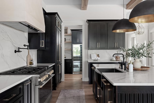 4896 Bethesda Rd, Thompsons Station, TN 37179 - kitchen with stainless steel range, custom exhaust hood, dark cabinetry, and beam ceiling