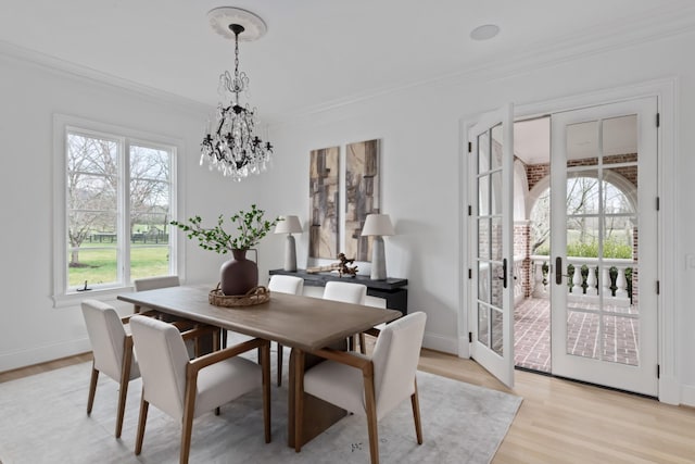 2455 Hidden River Ln, Franklin, TN 37069 - dining area with a chandelier, crown molding, and light wood-type flooring