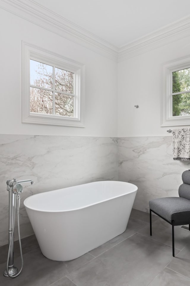 2455 Hidden River Ln, Franklin, TN 37069 - bathroom with a freestanding tub, crown molding, tile walls, and a wainscoted wall