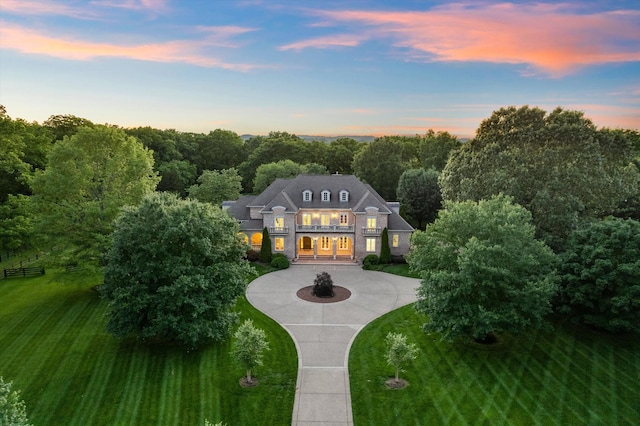 2455 Hidden River Ln, Franklin, TN 37069 - view of front facade featuring curved driveway, a balcony, and a lawn