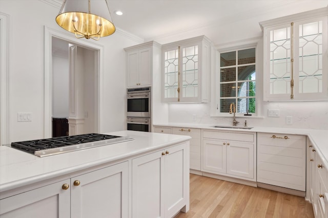 2455 Hidden River Ln, Franklin, TN 37069 - kitchen with appliances with stainless steel finishes, a chandelier, glass insert cabinets, light countertops, and light wood-style floors