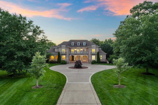 2455 Hidden River Ln, Franklin, TN 37069 - view of front of home with a balcony, a yard, curved driveway, brick siding, and stone siding