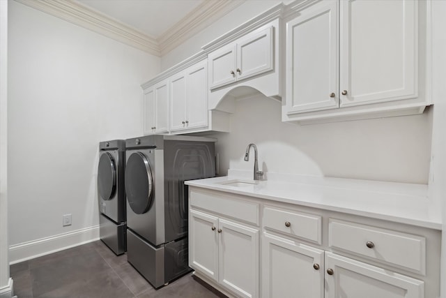 2455 Hidden River Ln, Franklin, TN 37069 - washroom with washing machine and dryer, cabinet space, ornamental molding, and dark tile patterned floors