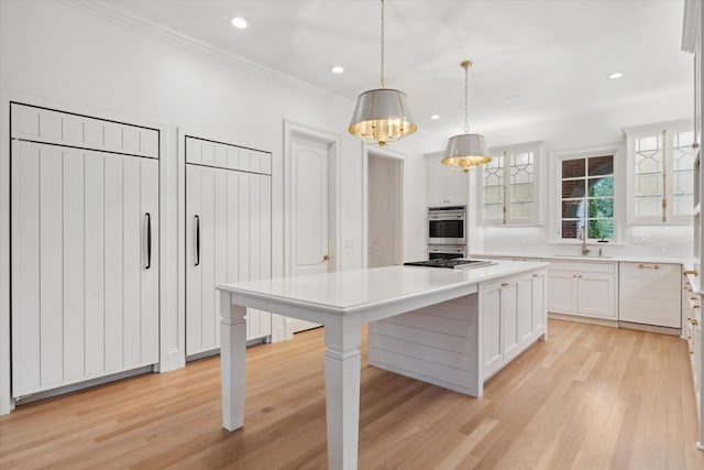 2455 Hidden River Ln, Franklin, TN 37069 - kitchen with glass insert cabinets, white cabinetry, stainless steel double oven, ornamental molding, and light countertops