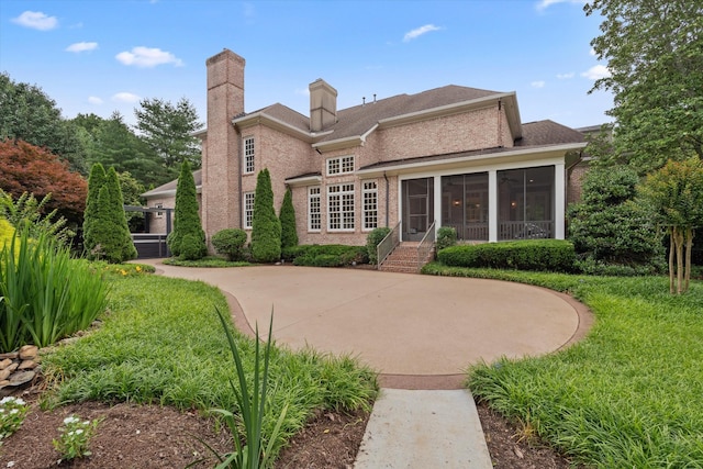 2455 Hidden River Ln, Franklin, TN 37069 - rear view of house with a sunroom, brick siding, and a chimney
