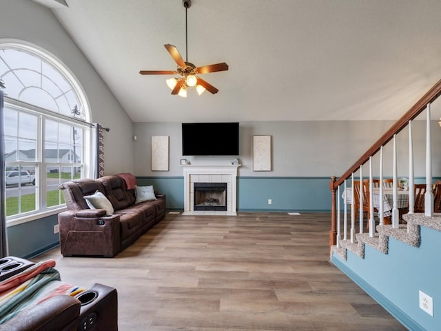 3786 Man O War Blvd, Clarksville, TN 37042 - living area featuring vaulted ceiling, ceiling fan, light wood-style flooring, a fireplace, and stairway
