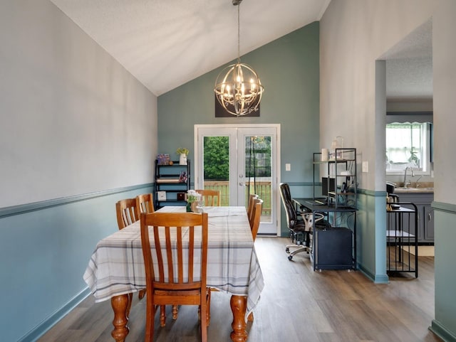 3786 Man O War Blvd, Clarksville, TN 37042 - dining area featuring a chandelier, wood finished floors, high vaulted ceiling, and french doors
