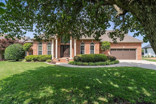 375 Natchez Trace Ct, Murfreesboro, TN 37127 - view of front facade with concrete driveway, brick siding, an attached garage, and a front yard
