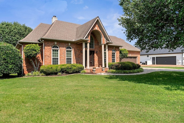 375 Natchez Trace Ct, Murfreesboro, TN 37127 - view of front of home with brick siding, driveway, an attached garage, and a front lawn