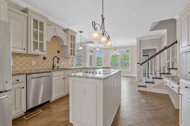 375 Natchez Trace Ct, Murfreesboro, TN 37127 - kitchen with appliances with stainless steel finishes, dark wood-style flooring, tasteful backsplash, glass insert cabinets, and crown molding