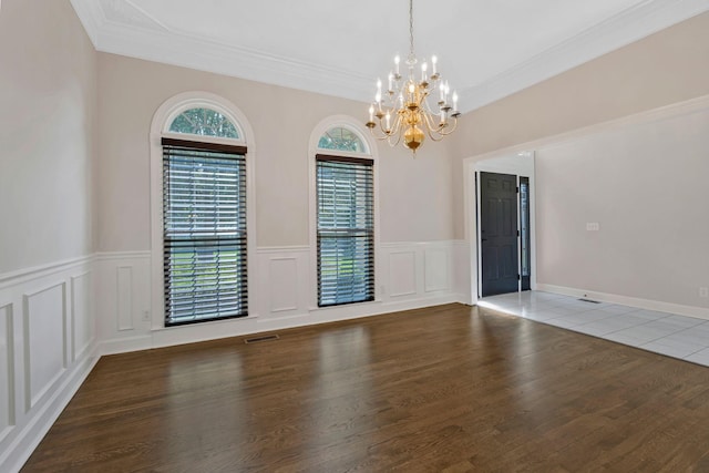 375 Natchez Trace Ct, Murfreesboro, TN 37127 - spare room featuring a chandelier, a decorative wall, ornamental molding, a wainscoted wall, and wood finished floors