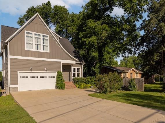 2207 Pennington Bend Rd Unit 3, Nashville, TN 37214 - view of front of property featuring an attached garage, driveway, a front lawn, and board and batten siding