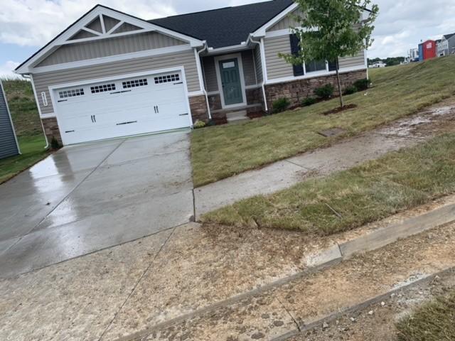 2500 Haskell Dr, Antioch, TN 37013 - craftsman house featuring concrete driveway, a garage, stone siding, and a front yard