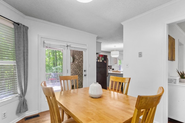 1830 Bradbury Rd, Adams, TN 37010 - dining area with a textured ceiling, healthy amount of natural light, crown molding, and light wood-style floors