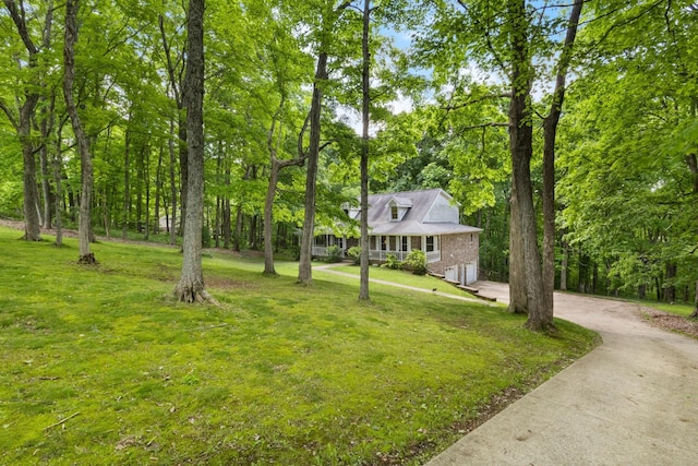 1830 Bradbury Rd, Adams, TN 37010 - view of front facade featuring driveway, an attached garage, a front lawn, and brick siding