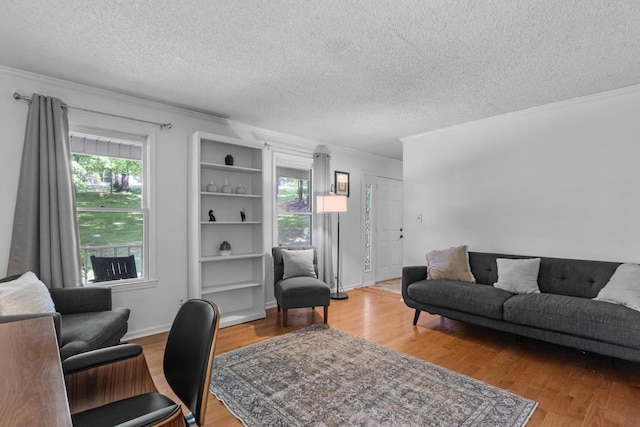 1830 Bradbury Rd, Adams, TN 37010 - living room with wood finished floors, a textured ceiling, and ornamental molding