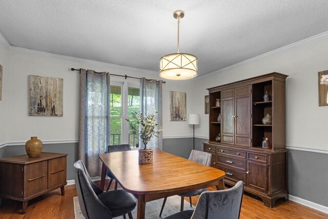1830 Bradbury Rd, Adams, TN 37010 - dining area with a textured ceiling, light wood-type flooring, and ornamental molding
