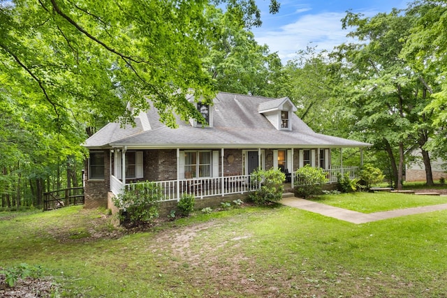 1830 Bradbury Rd, Adams, TN 37010 - country-style home featuring brick siding, a porch, a front yard, and a shingled roof