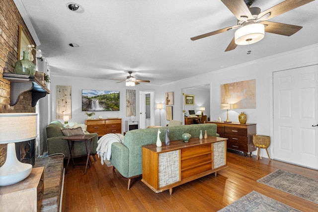 1830 Bradbury Rd, Adams, TN 37010 - living room with ceiling fan, wood-type flooring, crown molding, and a fireplace